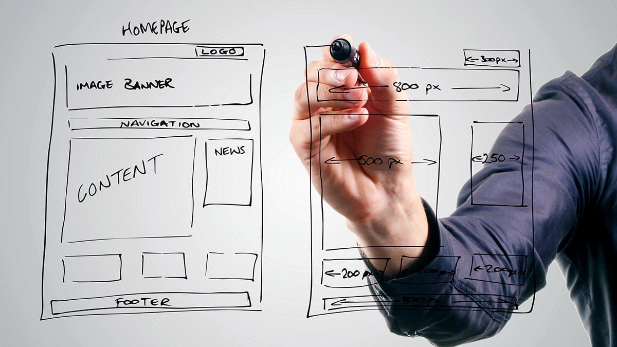 Male Drawing Website Framework on Screen with Black Dry Erase Marker