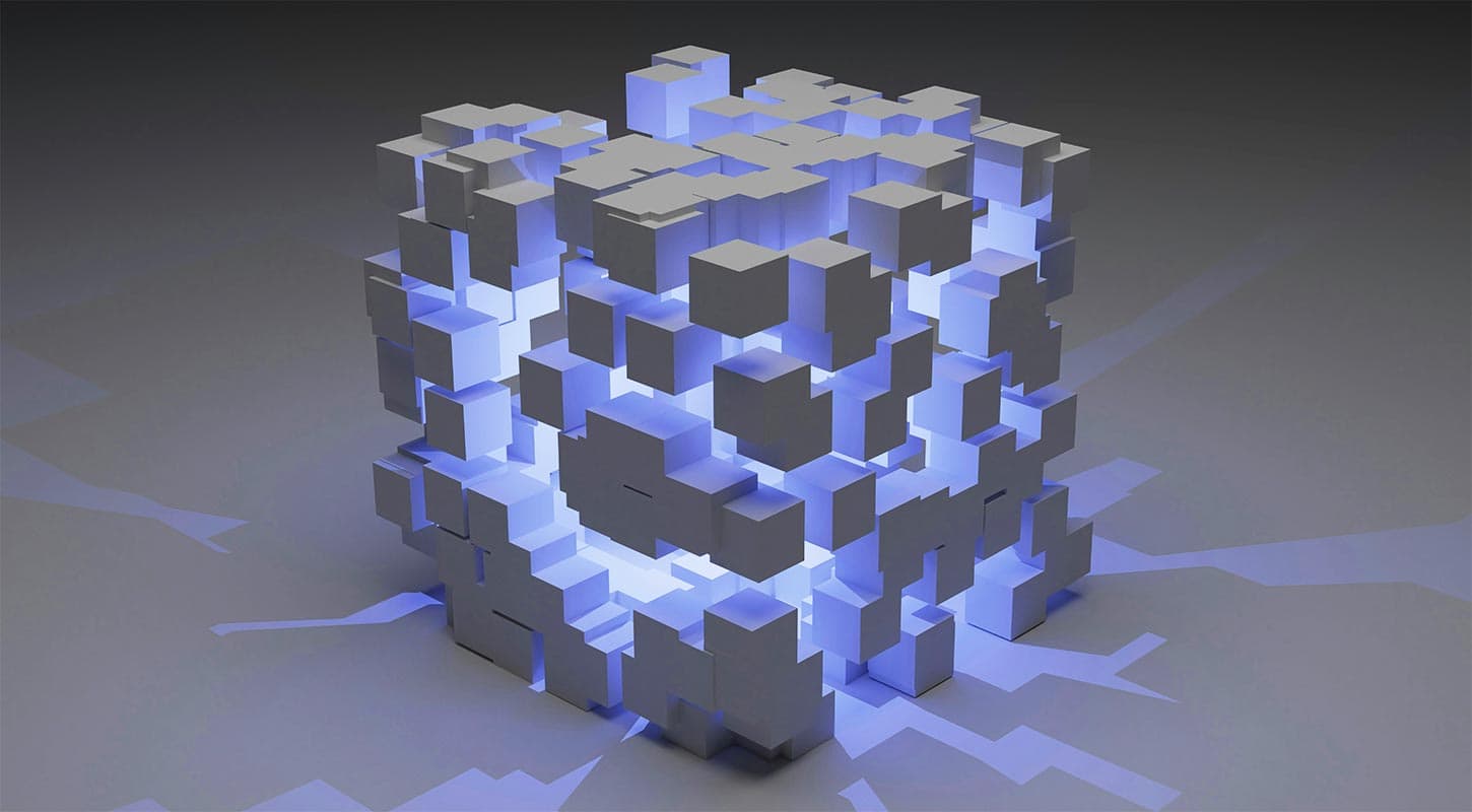 A 3D geometric cube composed of smaller interlocking blocks, illuminated from within by a blue light, casting intricate shadows on a dark surface. The design appears futuristic and abstract.