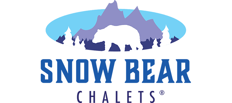 Logo showing a white bear silhouette walking in front of snowy trees and purple mountains, with “Snow Bear Chalets” written below in blue capital letters.